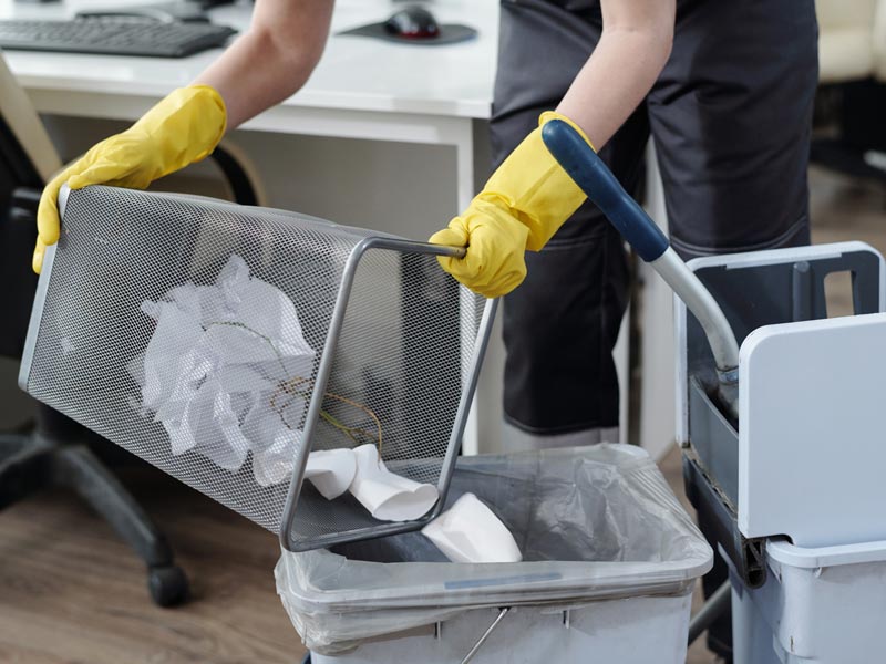 day porter emptying trash in office