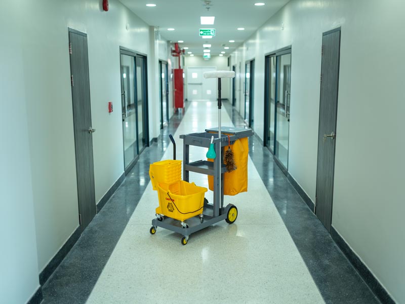 janitorial cart in commercial hallway