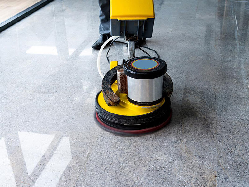 worker using machine to polish the floor